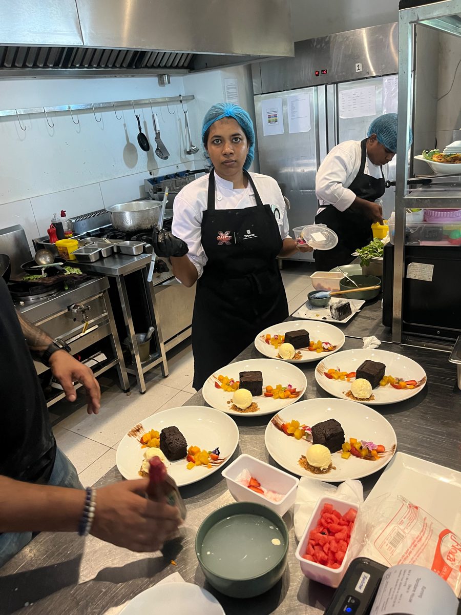 Chefs plating chocolate desserts for a full dining room at Taprobane House